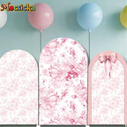 Fondo de arco personalizado rosa con lazo y flores, decoración para primer cumpleaños de niña, material spandex elástico, ideal para baby shower y fotografía de fiesta elegante.